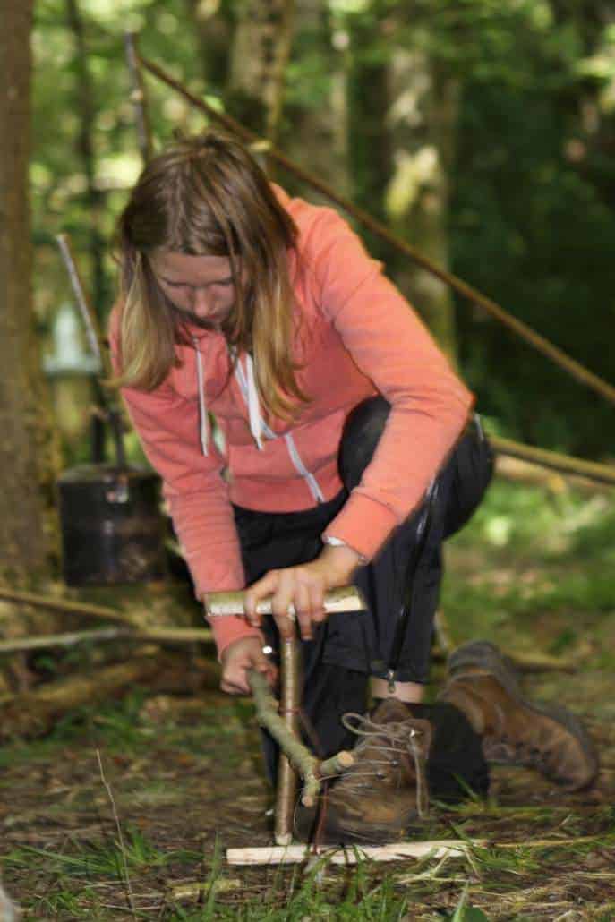 bow drill being used in the woods